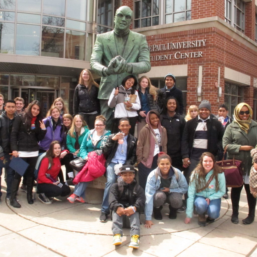 PS students standing in front of a statue on a college tour