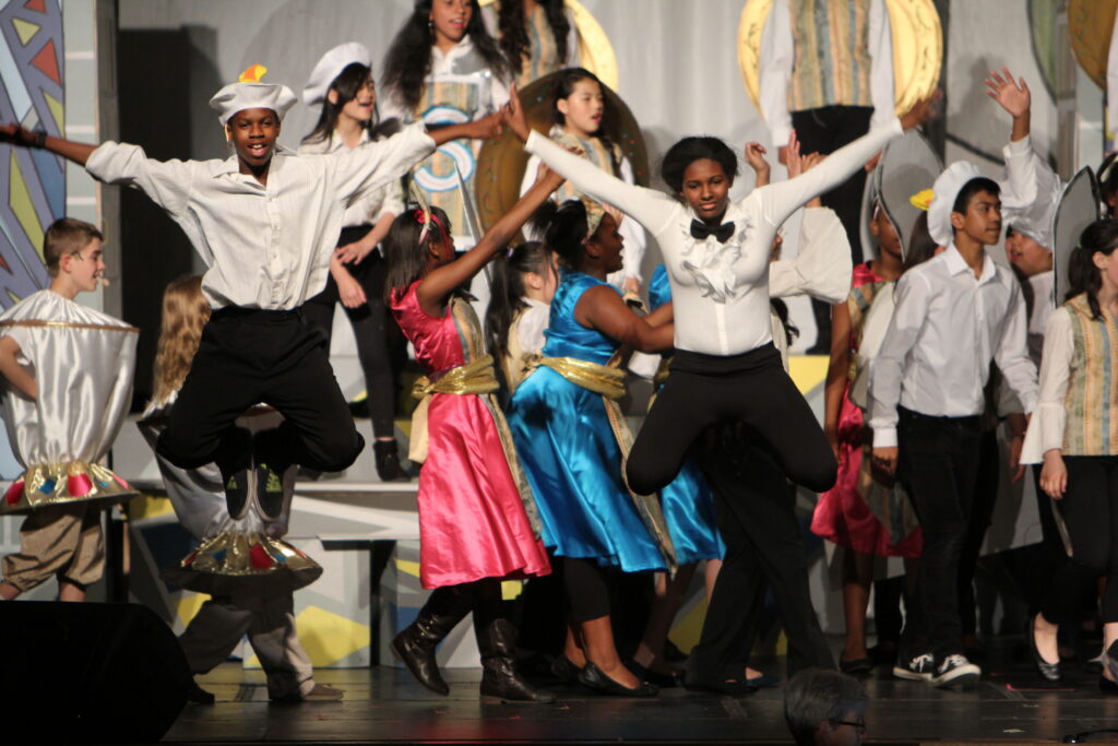 PS Students on stage for Beauty and the Beast performance