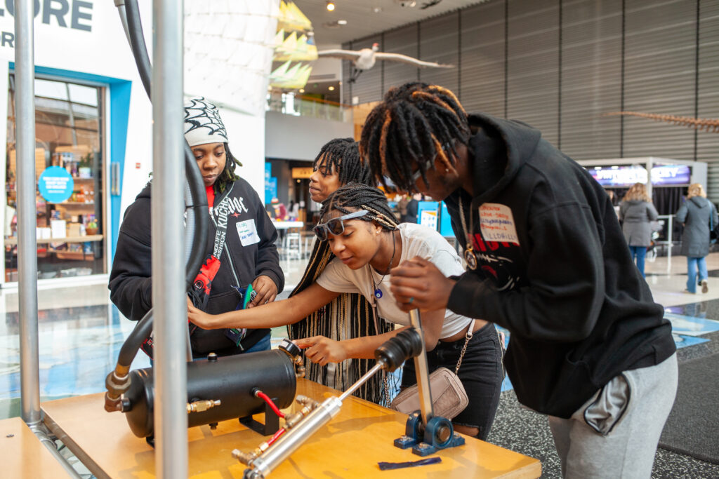 Students gathered together learning at MLK event at Science Museum.