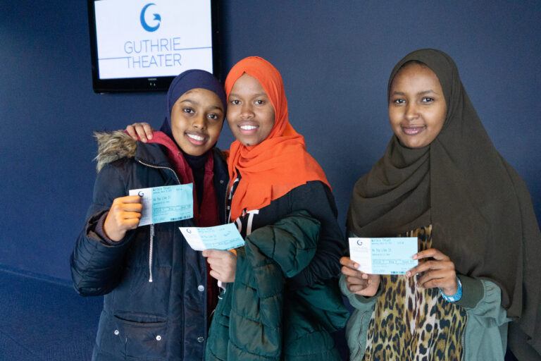 3 PS students posing with their tickets to a show at the Guthrie.