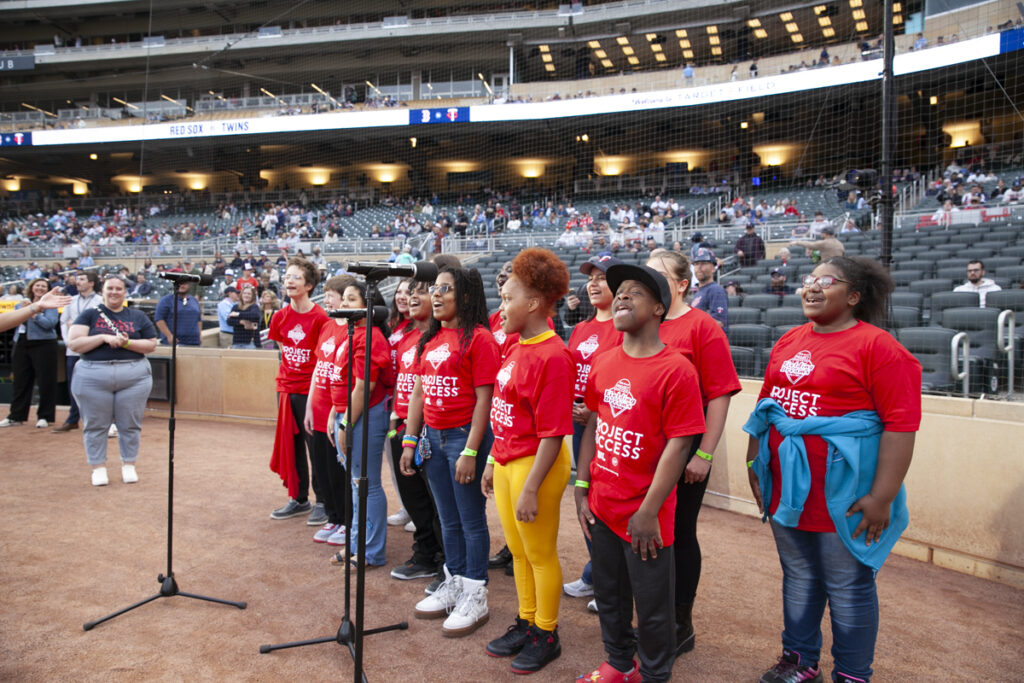 Students singing on the field at Fielding Dreams.