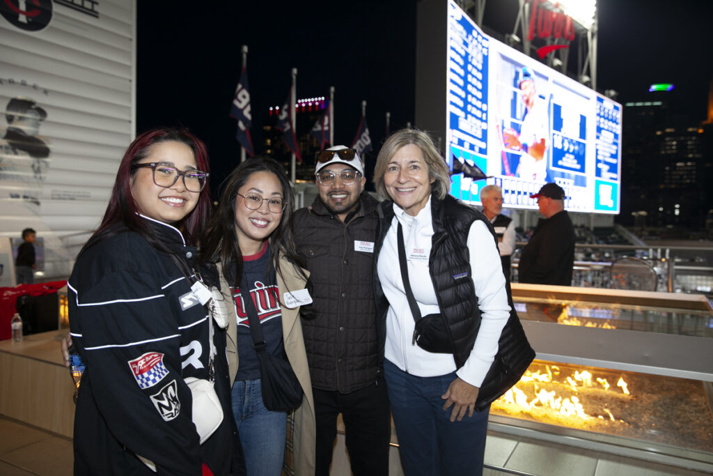 Group of four adults on Roof Deck at Twins game.