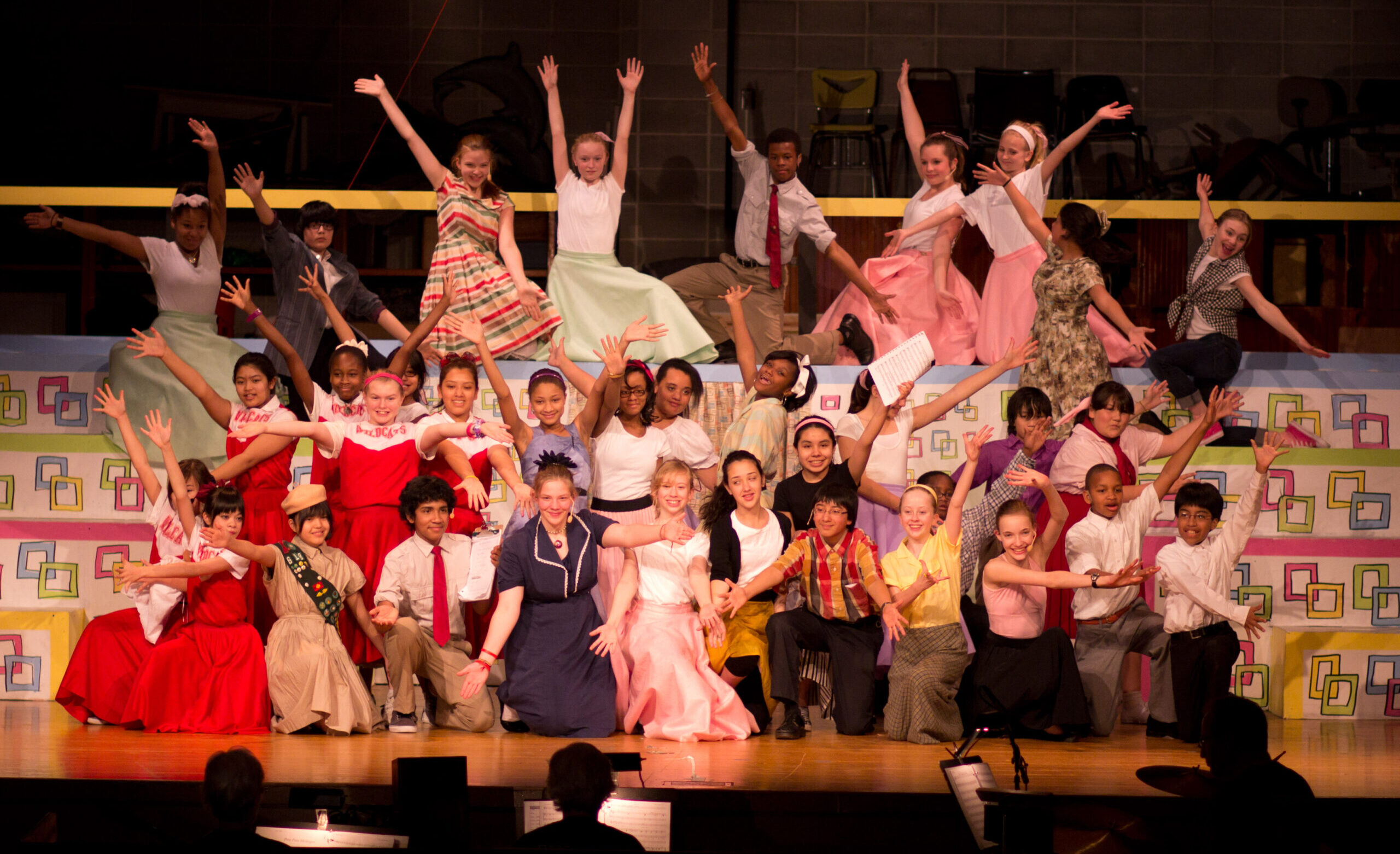 A large group of students in a PS musical on stage.