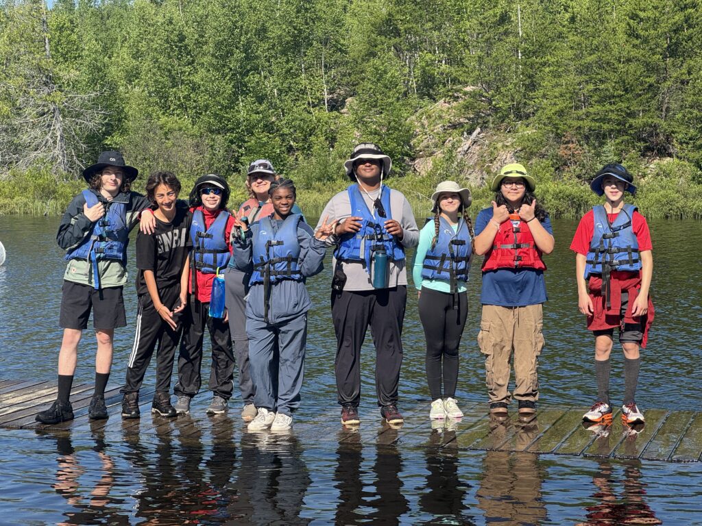 A group of students in the BWCA on the lake.