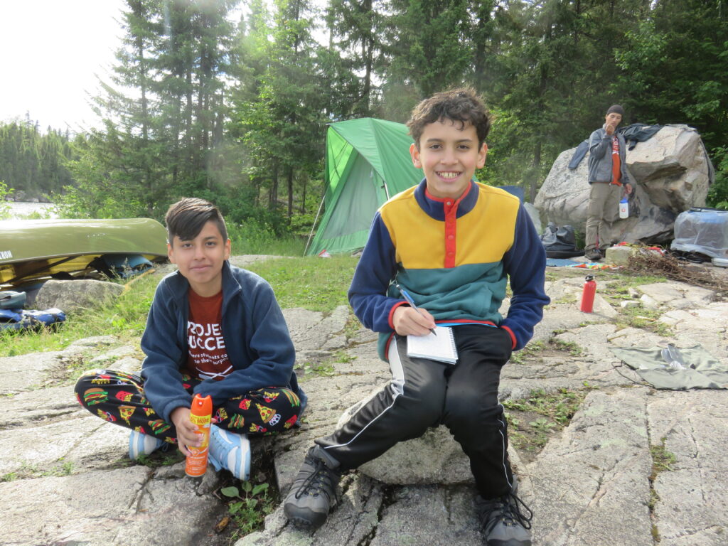 Two students at a campsite.