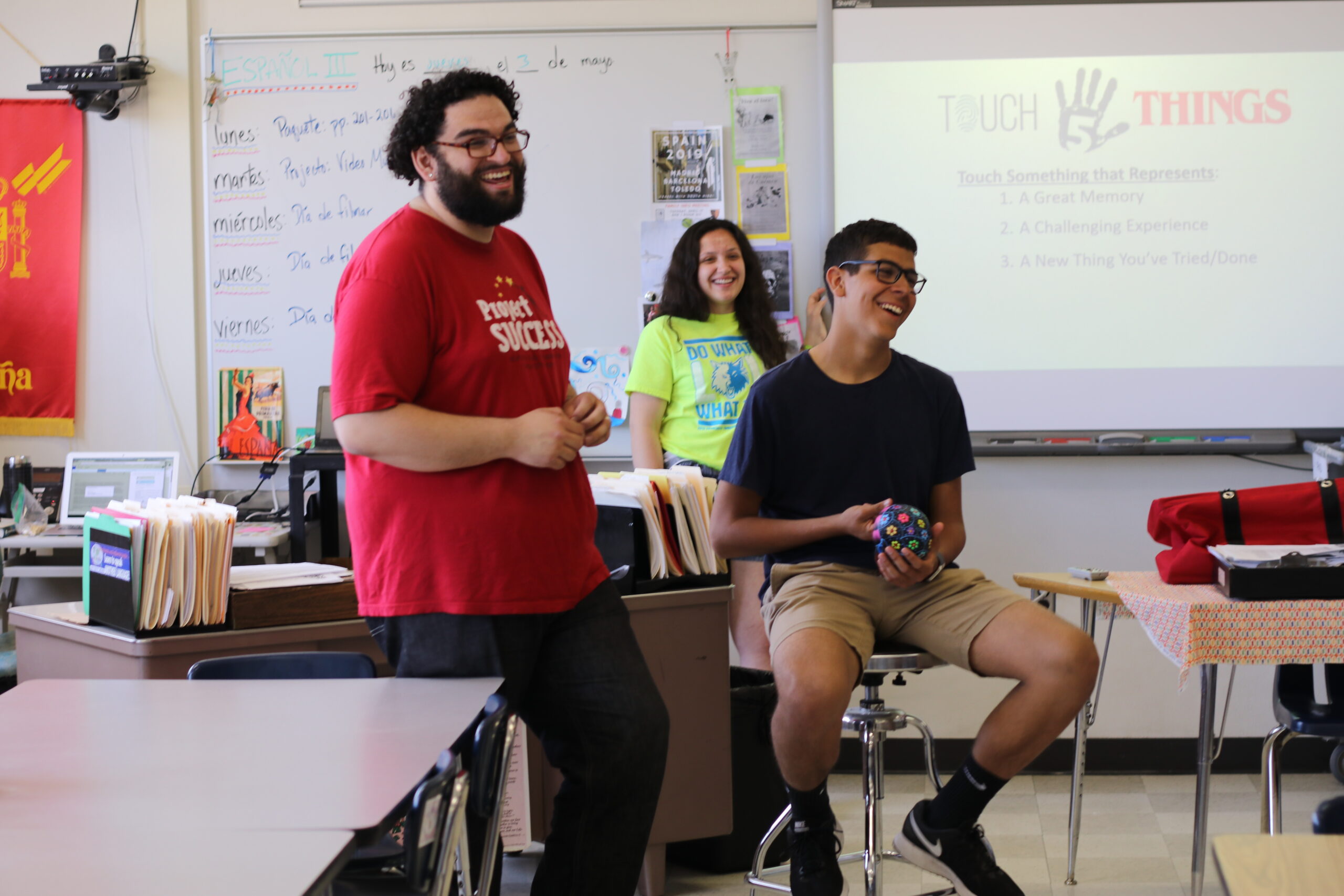 Marc, PS Facilitator, in the classroom with two students engaging in a PS workshop.