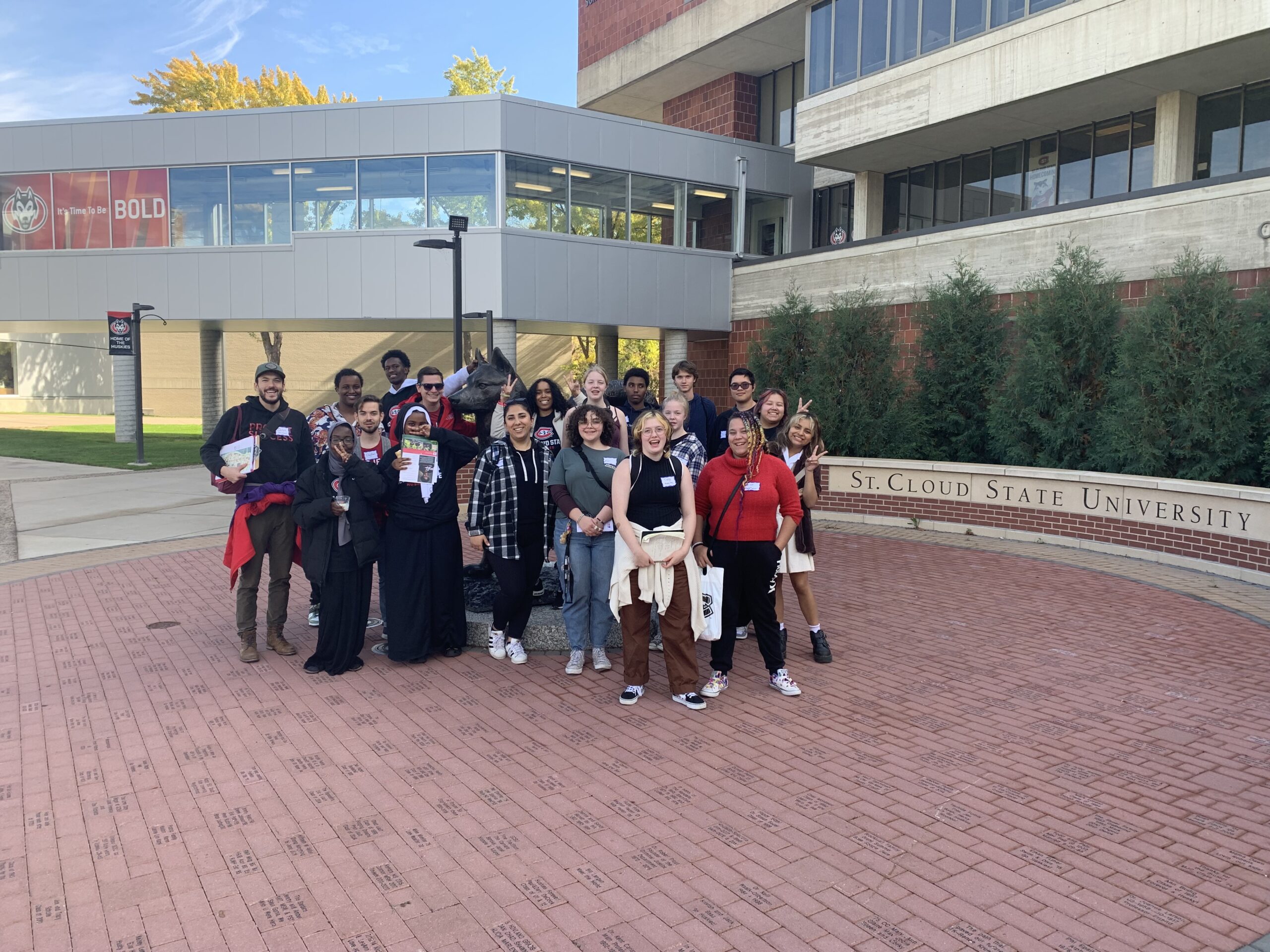 Group of PS students and staff posing infront of St. Cloud State sign