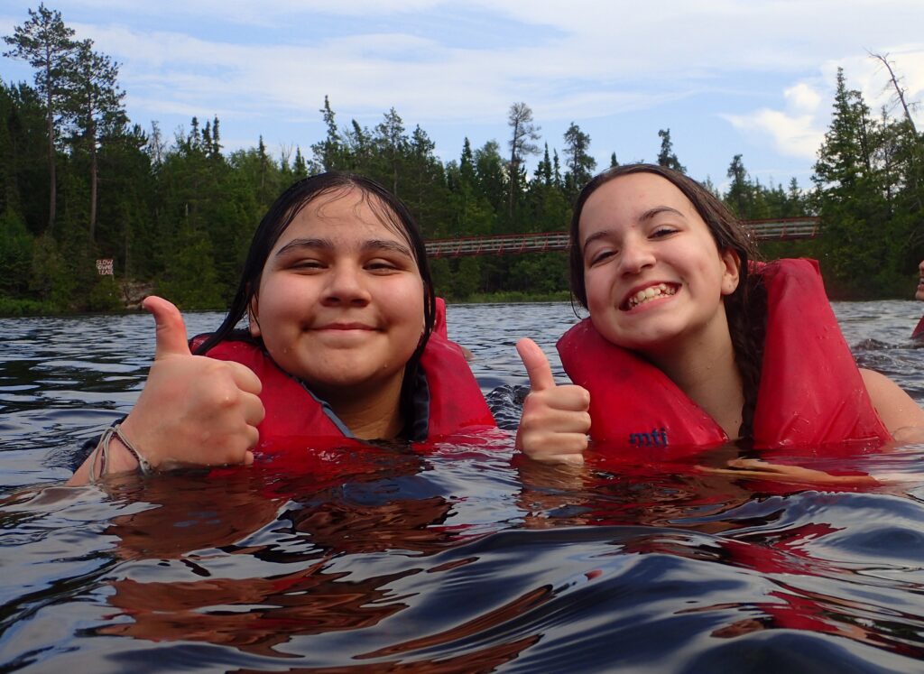 Two students floating in a BWCA lake.