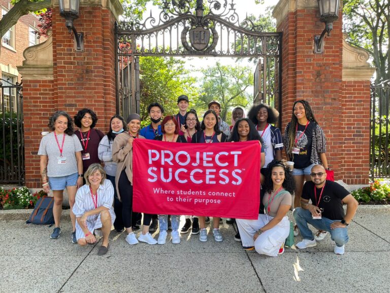 A group of PS students and staff in front of a college campus.