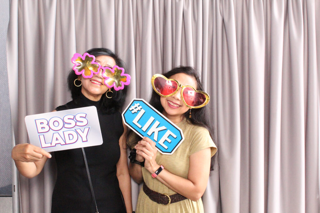 Two Project Success partner teachers and staff in the photo booth.