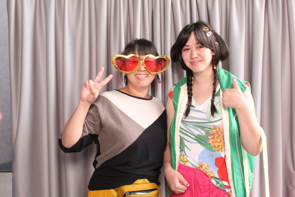 Two Project Success partner teachers and staff in the photo booth.