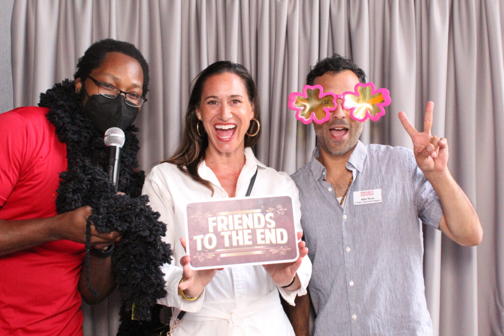 3 Project Success staff and teachers in the photobooth.