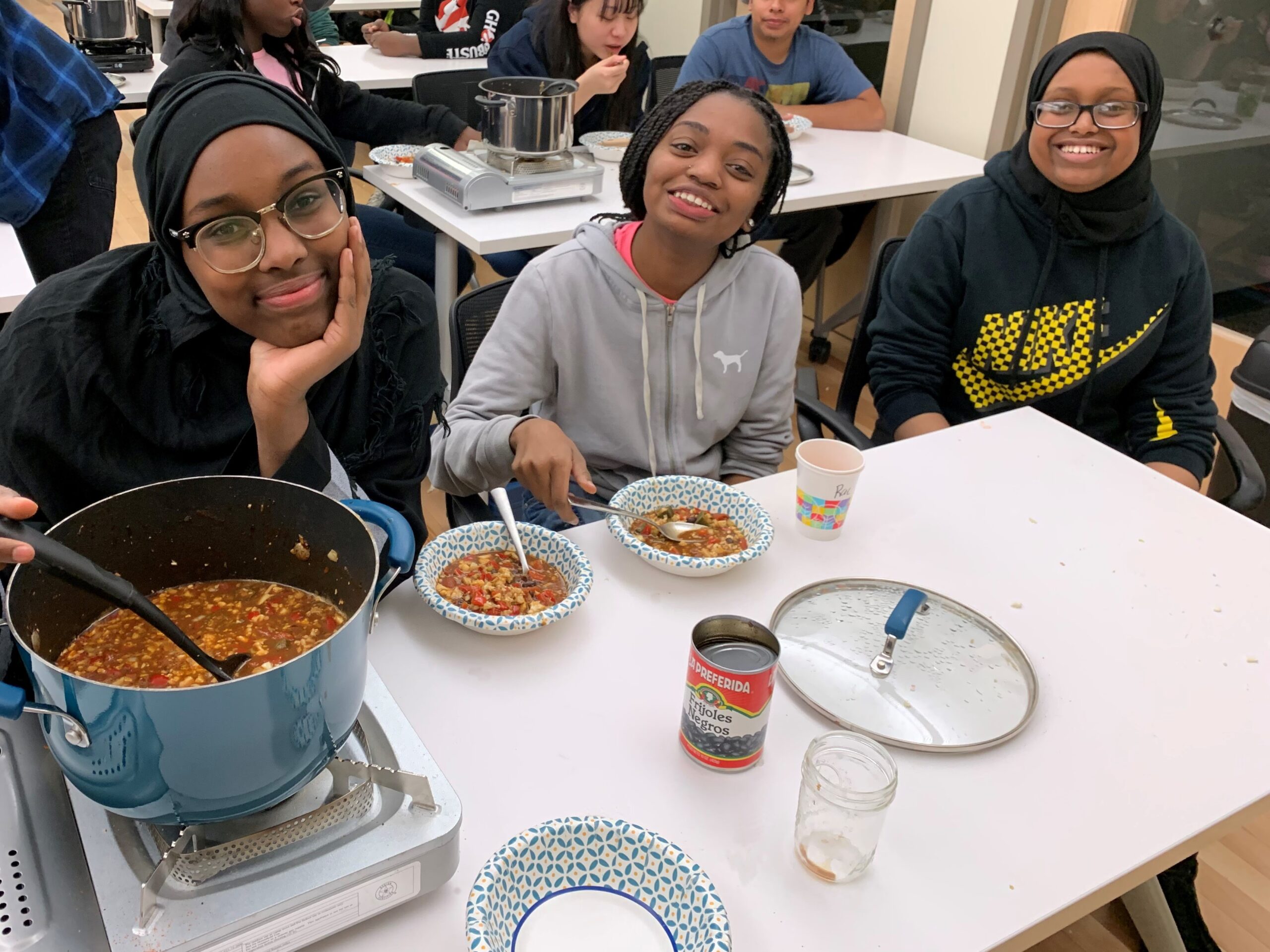 Three Project Success students eating food they've made.