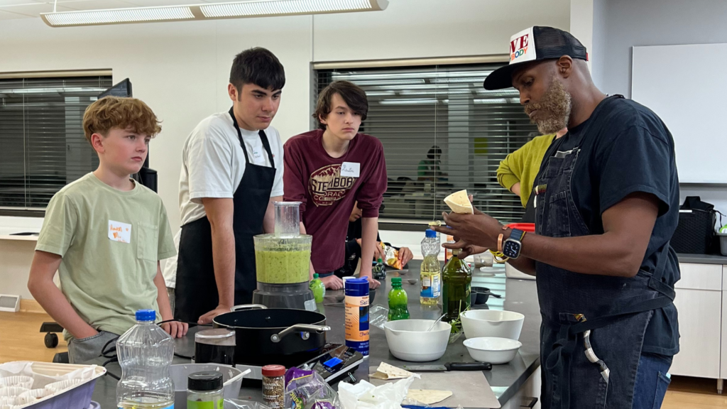 Guest chef showing students how to fold a sambusa.