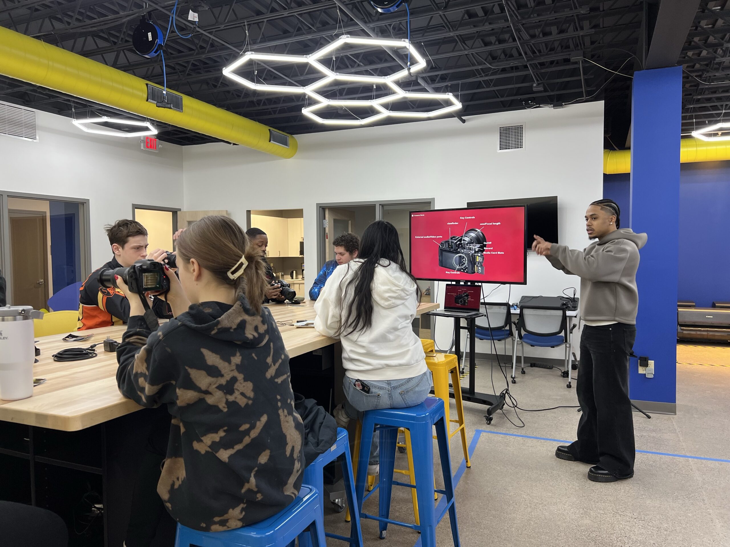 PS students gathered around a table in the Best Buy Teen Tech Center during a day of film.